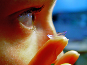 a girl putting in contact lenses